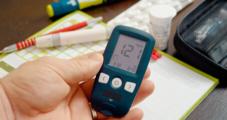 A glucometer reading slightly above normal shows a blood sugar level of 121, indicating prediabetes. Monitoring and lifestyle changes are essential for health management.