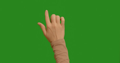 Woman clicking her finger in various places on a green screen. Female hand touching, tapping on chroma key green screen background. Interface concept. Single click and tap with finger.