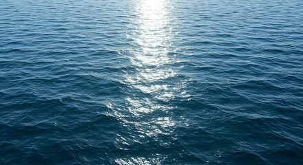 Naklejka premium Sunlit ocean water ripples a textured blue expanse with a bright reflective center