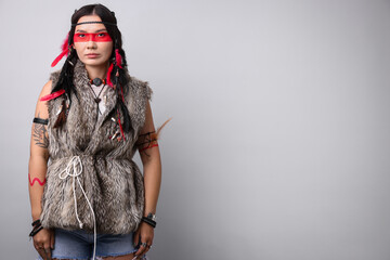 Shaman woman with face painting on light grey background, space for text