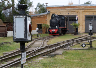An old steam locomotive engine in depot.