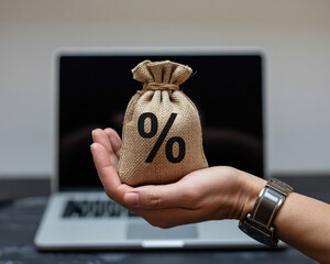 Secure your financial future with this lucrative interest rate offer presented by a professional hand holding a money bag