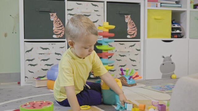 Toddler boy playing with educational shape sorter toy