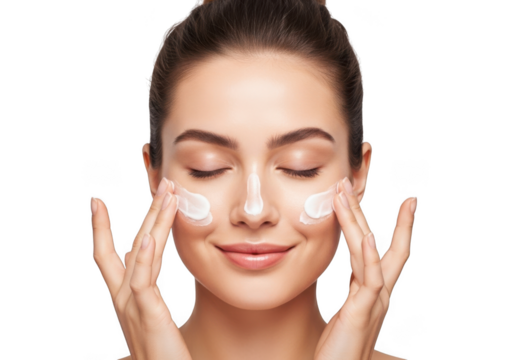 Beautiful young woman applying face cream isolated on transparent background