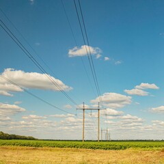 Power lines and power line pylons, electrical wires stretch across the rural landscape. Power lines...