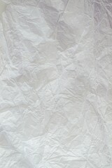 Crumpled white paper background. Crumpled paper texture, top view, copy space.