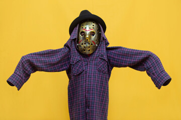 Spooky Halloween Fun: Child in Horror Mask and Scarecrow Costume