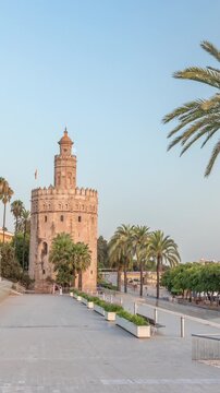 Torre del Oro timelapse hyperlapse, a dodecagonal military watchtower in Seville, Spain. Built by the Almohads to control Guadalquivir River access. Historic landmark at evening before sunset
