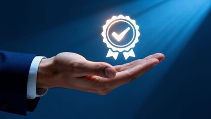 A businessman's hand holding a glowing quality assurance icon. Certification, standard, and guarantee concept for business excellence and top service