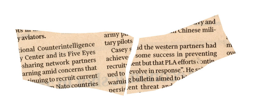 Newspaper with torn edge and text close up detail view of paper