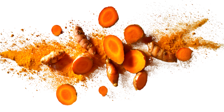 Exploding turmeric root and slices with powder against black background