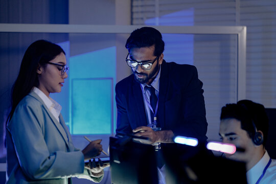 Code review huddle ignites problem solving Senior dev guides colleagues analyzing script tablet screen shows logic fix discussed modern dev hub collaboration conquers challenges now win.