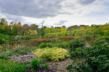 Rivierenhof Botanical Garden in October in Deurne, Belgium. Under a dark, cloudy sky.