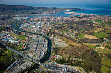 The aerial view captures the beautiful landscapes around Peage Biriatou and Hendaye, featuring lush greenery, winding rivers, and a coastal town under a clear blue sky.