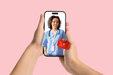 Patient holding smartphone with female doctor holding first aid kit against pink background....