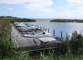 Obraz premium Wooden dock and boats on a fjord in Ringkøbing, Denmark