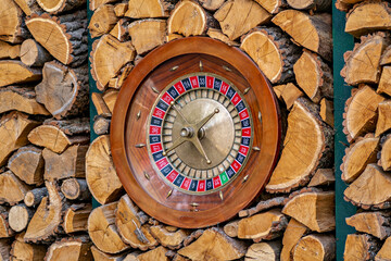 A roulette wheel is set into a wooden wall