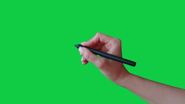 A woman's hand draws a cross with a stylus. Female hand gesture drawing with stylus on chroma key green screen background. Girl's hand guesture with stylus: crossing out, negation, deletion, say no