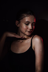 Portrait of a girl on a dark background. Makeup.