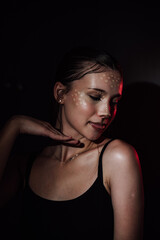Naklejka premium Portrait of a girl on a dark background. Makeup.