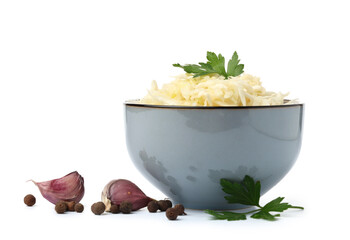 Bowl with tasty sauerkraut and different spices on white background