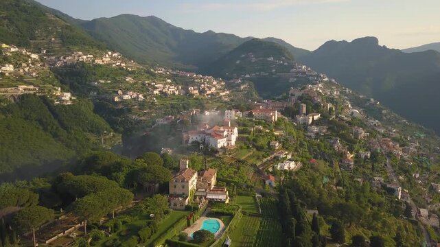 Aerial view of Ravello at sunrise, showcasing greenery and buildings