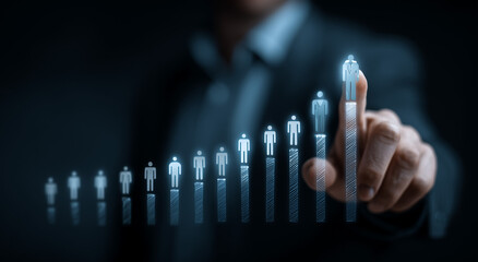 Businessman interacting with a futuristic virtual screen displaying a rising bar graph of people icons symbolizing growth and success