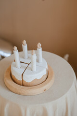 Wooden Toy Cake with Candles on Decorative Tablecloth