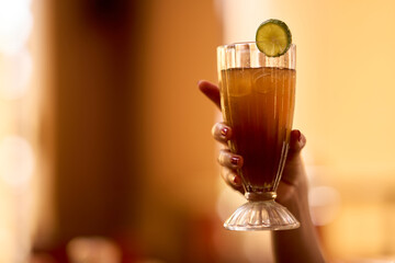 Female hand holding a mule glass