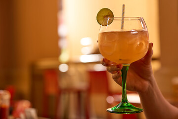 Female hand holding a mule glass