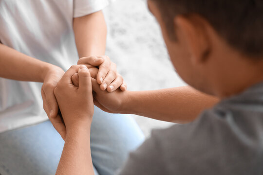 Woman supporting man with suicidal thoughts at home, closeup