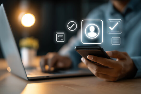 Person using smartphone and laptop with digital interface icons for online task management
