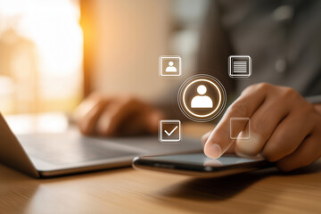 Close-up of hands using smartphone and laptop with digital profile icons overlaid digital interface.