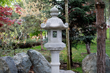Traditional Japanese style stone lantern in garden - toro