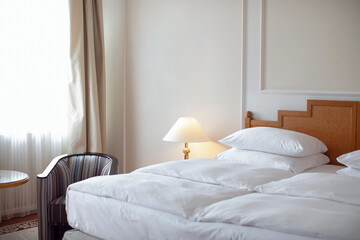 Beautiful bedroom in beige and brown colours with electric lamps