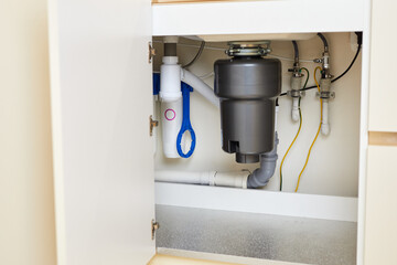 The installation of a functional garbage disposal unit beneath the kitchen sink showcases essential...