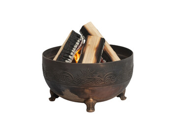 An ornate bronze fire pit with burning wood logs and glowing flames, set against a solid transparent background. background removed