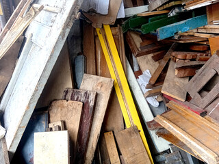Pile of wooden and planks. Pieces of wood cut into planks. Old and used wood.