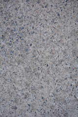 Close-up texture of granite wall with gray stone pattern in speckled concrete