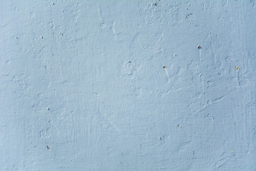 Smooth painted wall surface in pale blue tone with subtle texture