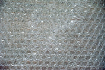 Bubble wrap texture close-up with transparent air pockets and soft reflections
