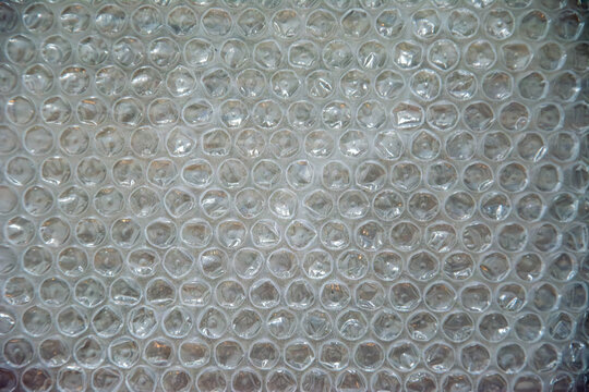 Bubble wrap texture close-up with transparent air pockets and soft reflections - Powered by Adobe