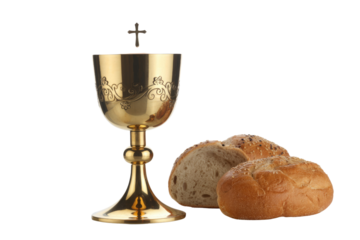 A golden chalice with intricate carvings and a cross above, accompanied by bread rolls, representing Christian Holy Communion. background removed