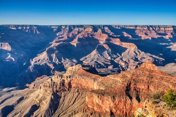 Grand Canyon National Park captivates visitors with its immense canyons, vibrant rock colors, and breathtaking views. A true natural wonder. Travel in ArizonaUSA. High quality photo