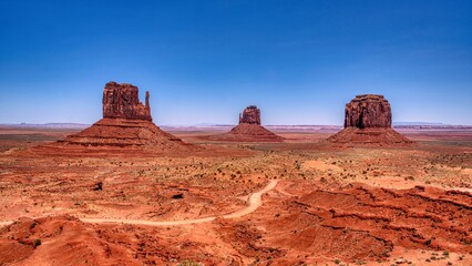 Monument Valley impresses with its red mesas and vast desert – an iconic, serene backdrop to the American West. Arizona. High quality photo.