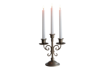 An elegant, antique-style bronze candelabra holds three lit white taper candles, casting a warm glow, perfect for ambience. background removed