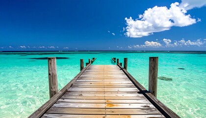 Serene wooden pier stretching into clear turquoise waters on a sunny day