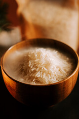 Long grain white rice served in a wooden bowl against a soft backdrop