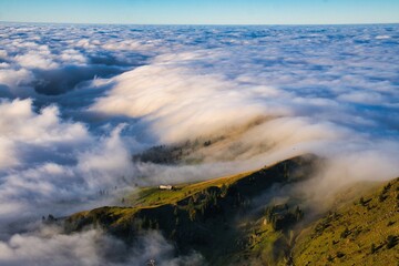 An alpine pasture in a sea of ​​fog. High quality photo.