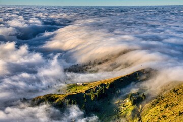 Autumn hike above the sea of ​​fog to Mount Speer. Beautiful views above the fog of the surrounding mountains. Fantastic mountain scenery in Switzerland. Wanderlust. High quality photo.